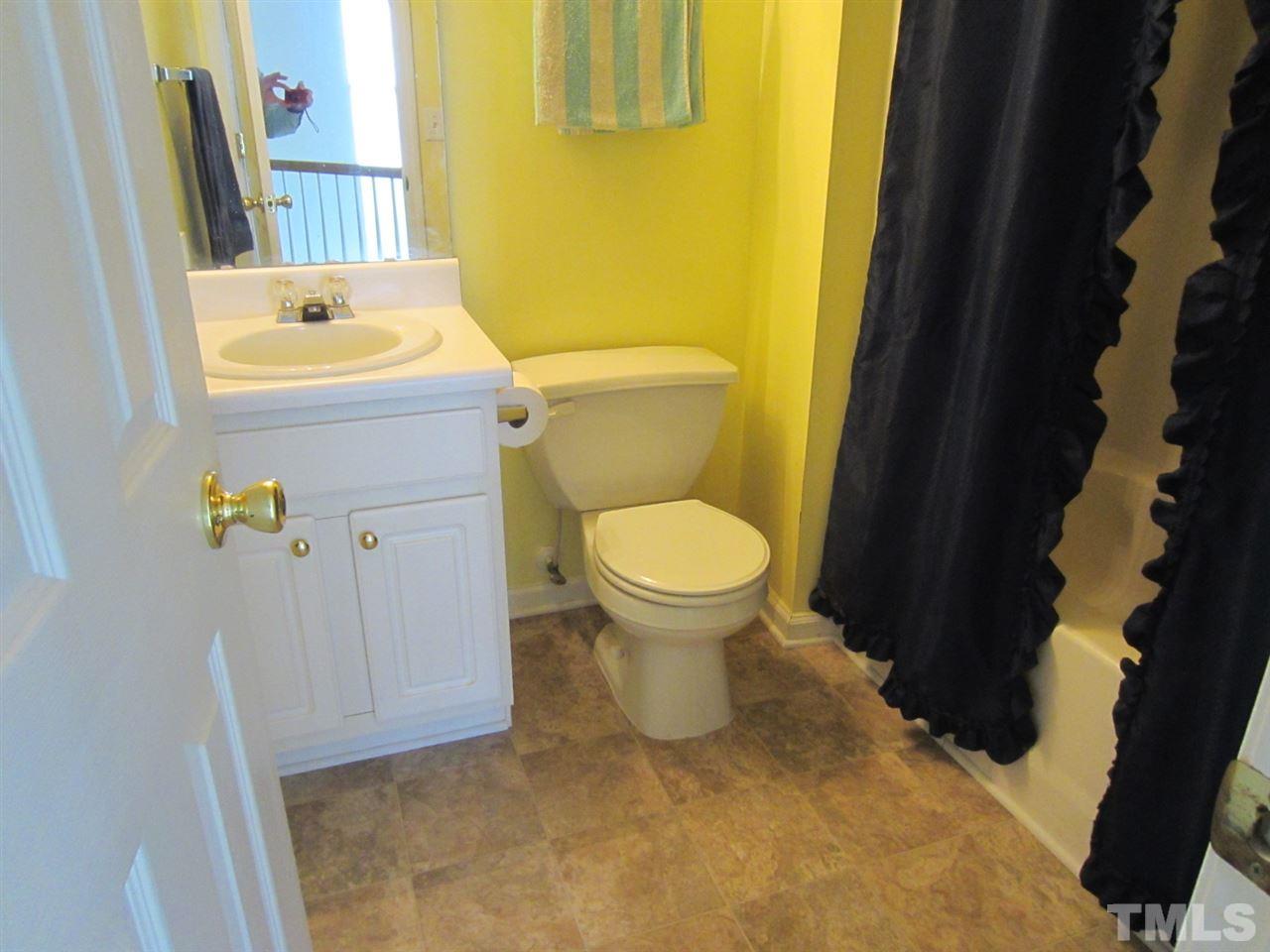 9901 Treymore Drive Raleigh, NC 27617 - Photo 18 of 25 a bathroom with a sink toilet and shower