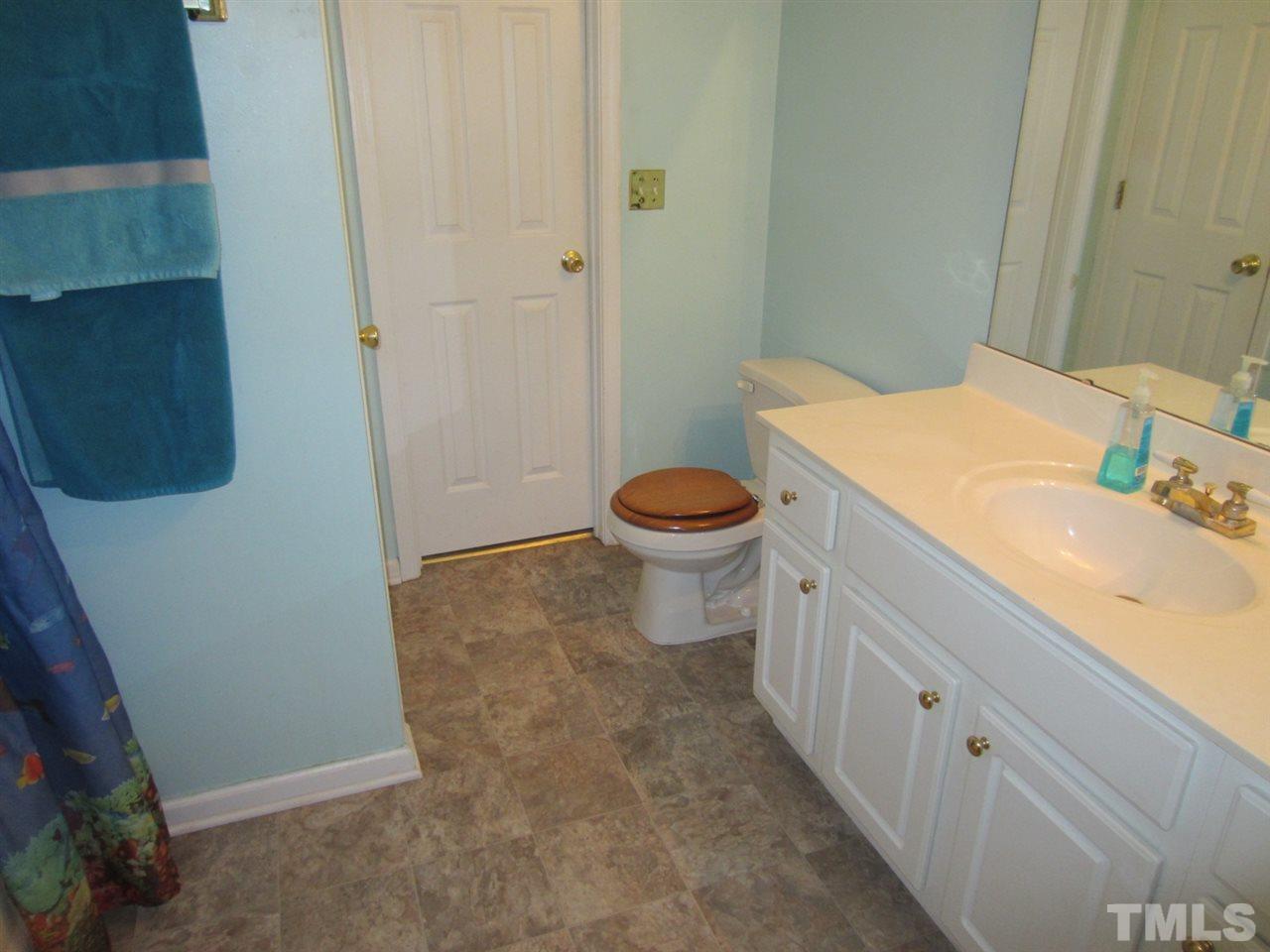9901 Treymore Drive Raleigh, NC 27617 - Photo 19 of 25 a bathroom with a sink a toilet and shower