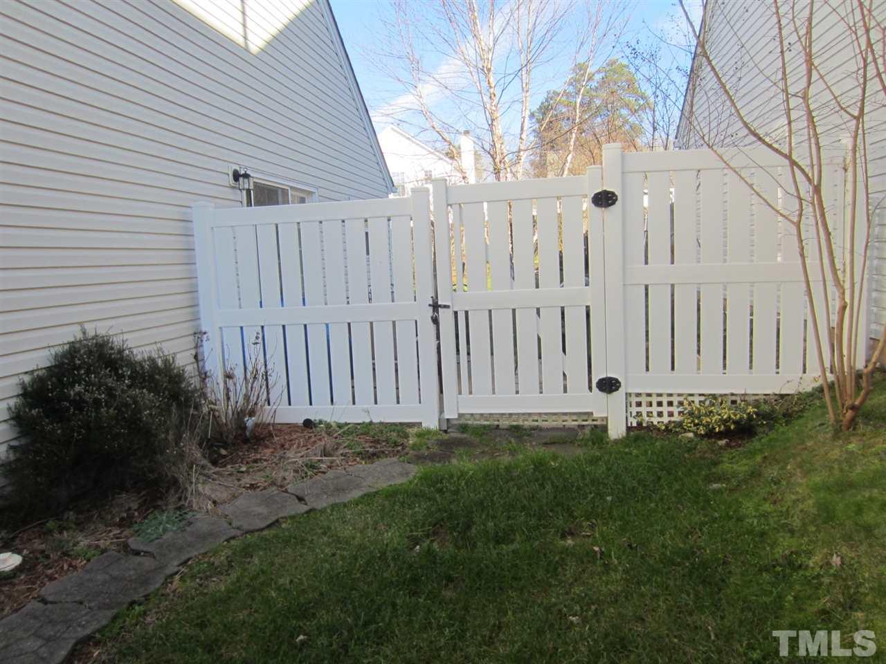 9901 Treymore Drive Raleigh, NC 27617 - Photo 22 of 25 a view of a backyard with white fence