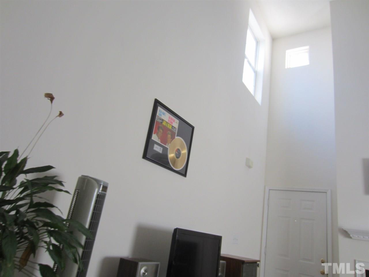 9901 Treymore Drive Raleigh, NC 27617 - Photo 23 of 25 a view of a workspace with furniture and a potted plant