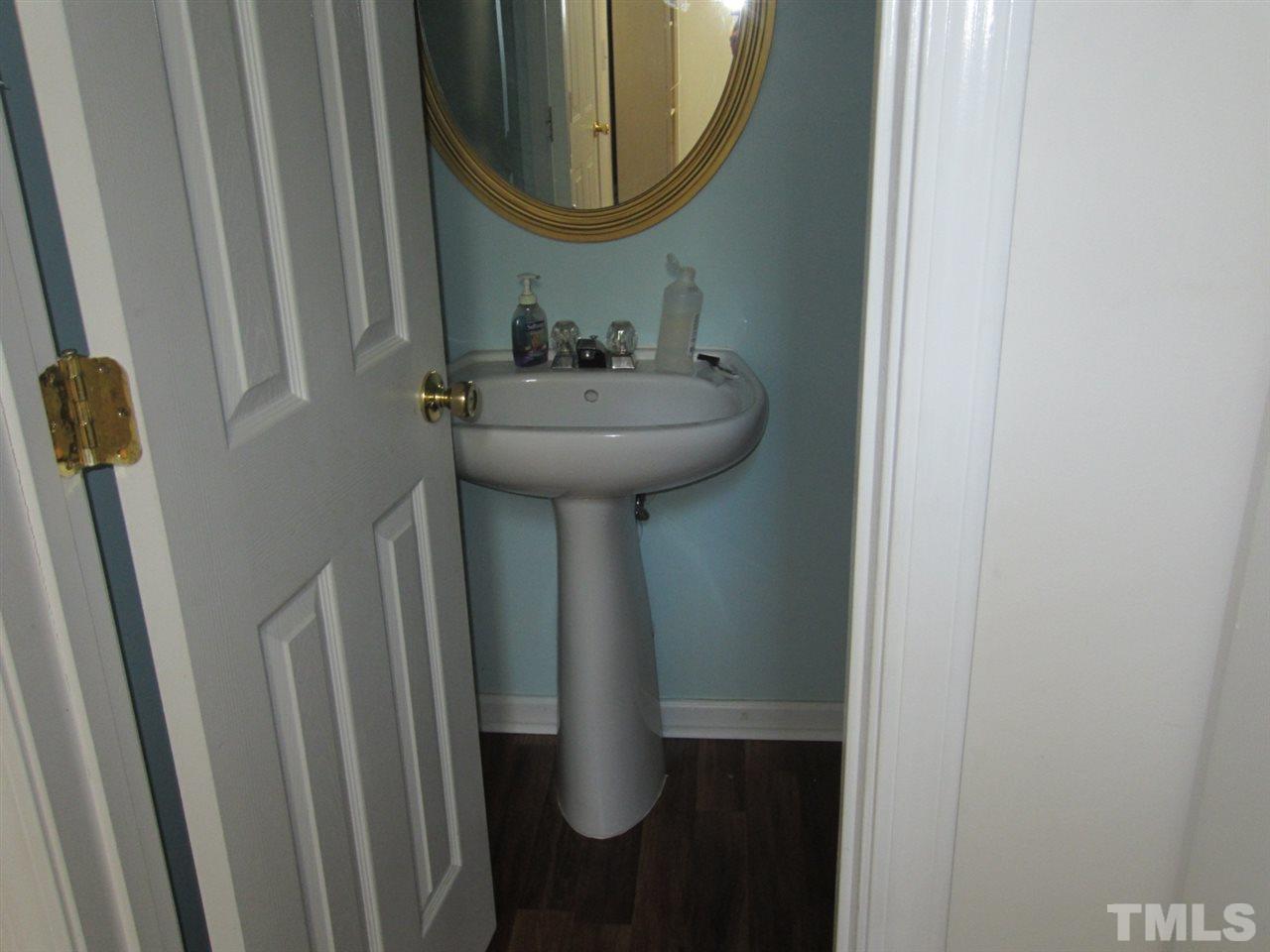 9901 Treymore Drive Raleigh, NC 27617 - Photo 24 of 25 a bathroom with a sink and mirror