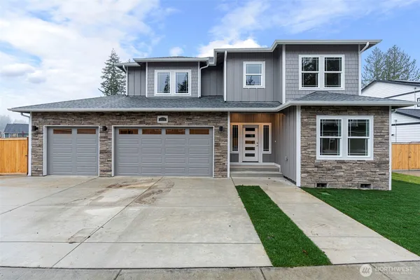 a front view of a house with a yard and garage