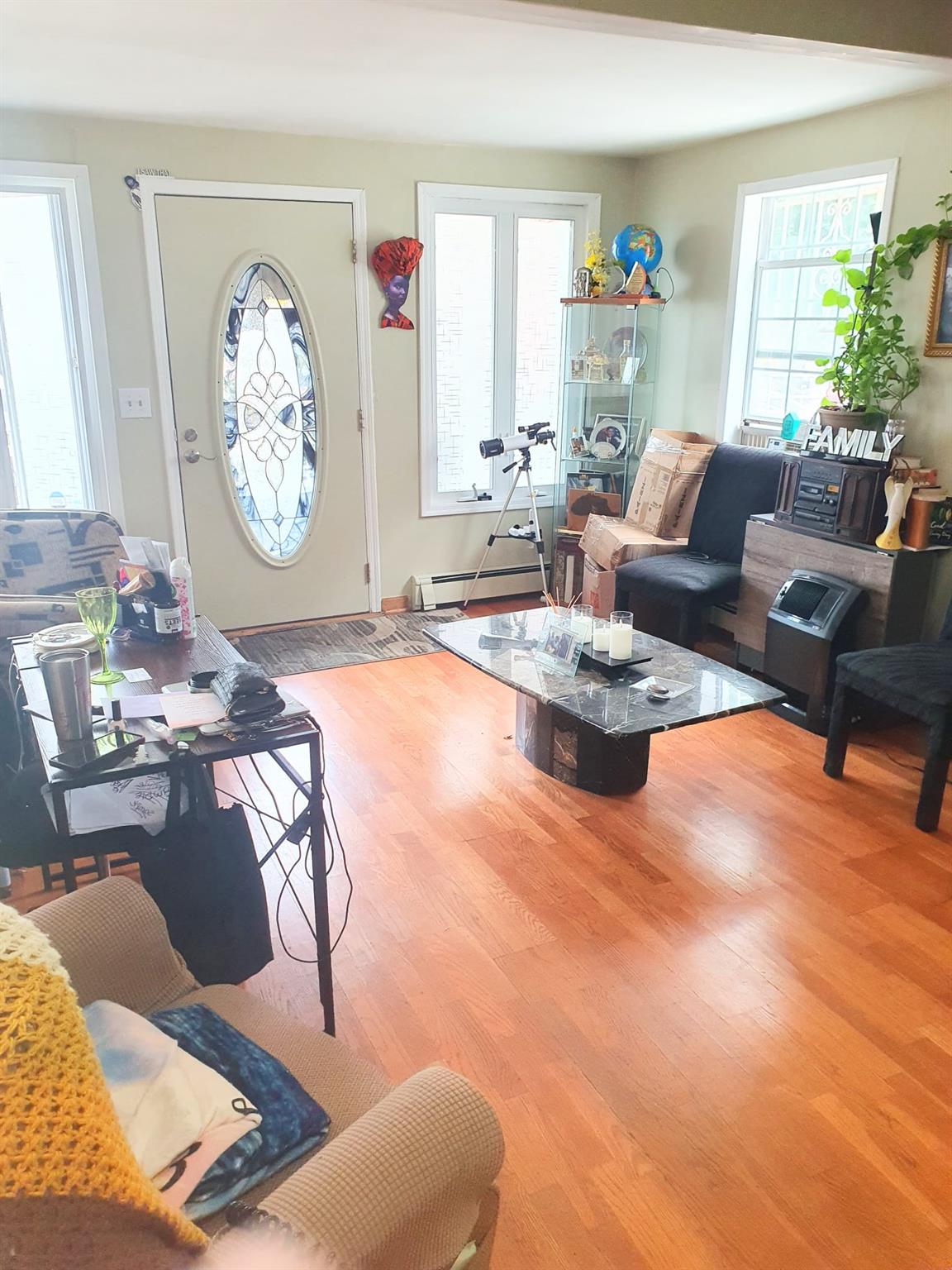 128-26 Gotham Road Queens, NY 11420 - Photo 3 of 16 a living room with furniture and a large window