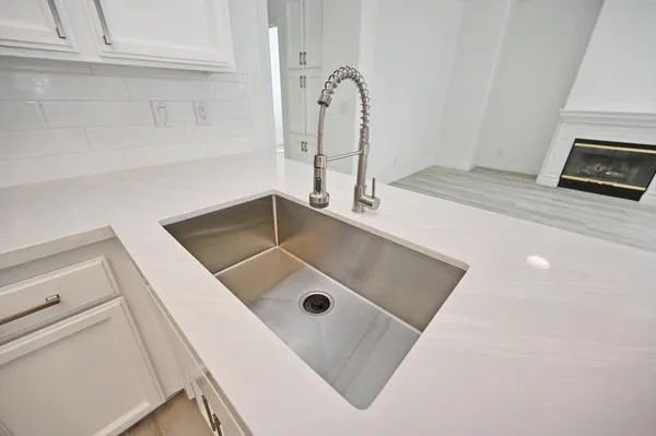 a bathroom with a sink a toilet a mirror and shower