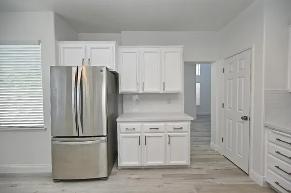 an empty room with a window and ceiling fan