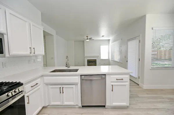 an empty room with a window and a fan