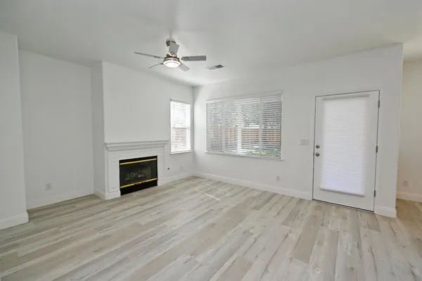wooden floor in an empty room with a window