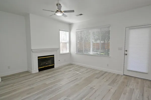 a view of balcony with wooden floor and fence