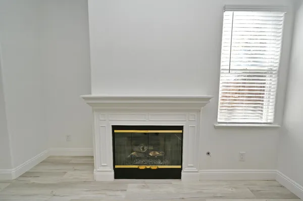 a bathroom with a tub a sink and a window