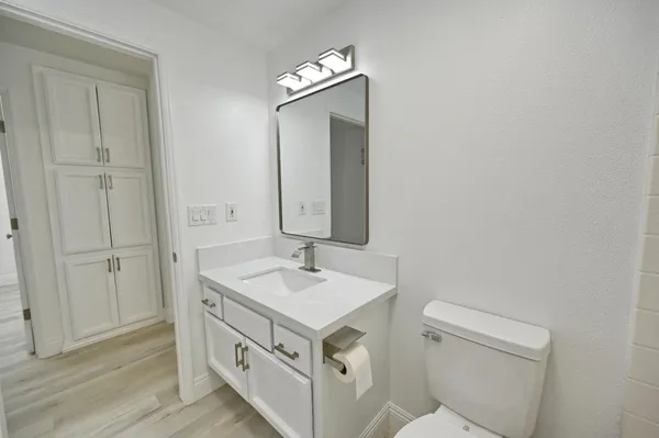 a view of a workspace with furniture and wooden floor