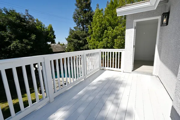 a balcony with table and chairs