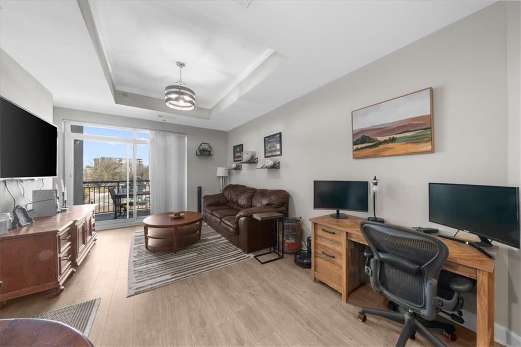 325 East Paces Ferry Road Northeast, Unit 504 Atlanta, GA 30305 - Photo 11 of 45 a view of a livingroom with workspace and a couch