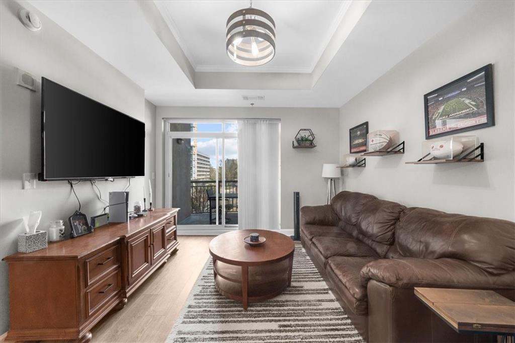 325 East Paces Ferry Road Northeast, Unit 504 Atlanta, GA 30305 - Photo 12 of 45 a living room with furniture and a flat screen tv