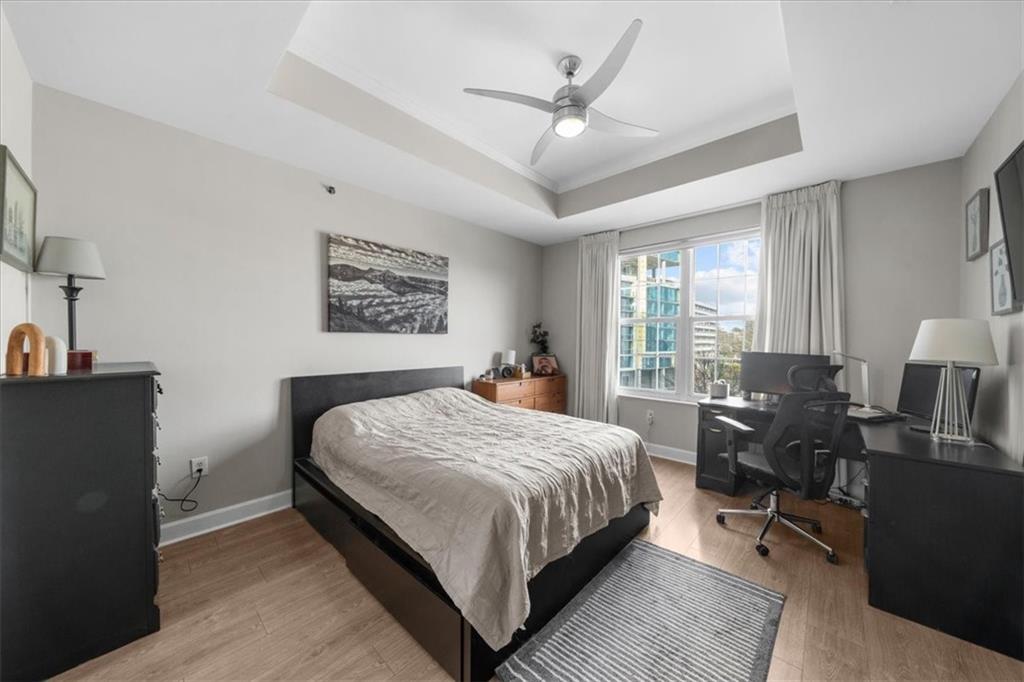 325 East Paces Ferry Road Northeast, Unit 504 Atlanta, GA 30305 - Photo 15 of 45 a bedroom with a bed a dresser and chair