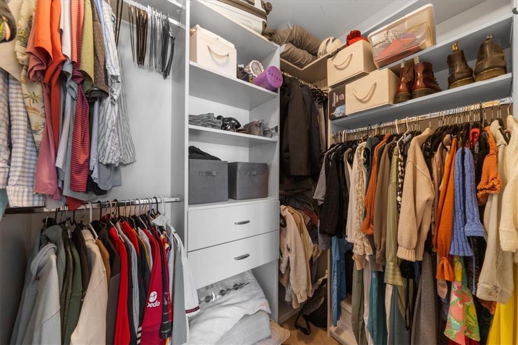 325 East Paces Ferry Road Northeast, Unit 504 Atlanta, GA 30305 - Photo 18 of 45 a view of walk in closet with clothes and shoes