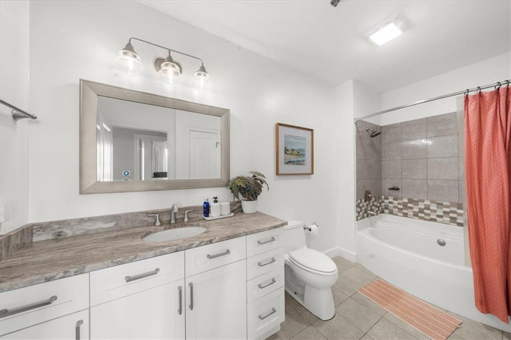 325 East Paces Ferry Road Northeast, Unit 504 Atlanta, GA 30305 - Photo 19 of 45 a bathroom with a granite countertop sink toilet tub and shower
