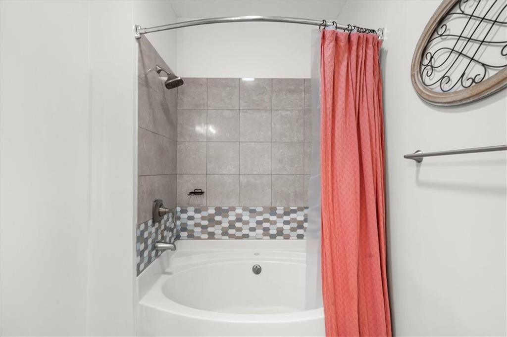 325 East Paces Ferry Road Northeast, Unit 504 Atlanta, GA 30305 - Photo 21 of 45 a bathroom with a bathtub and shower