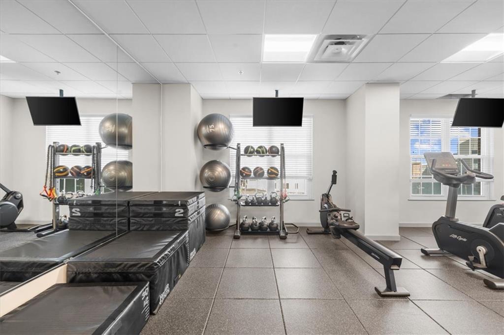325 East Paces Ferry Road Northeast, Unit 504 Atlanta, GA 30305 - Photo 33 of 45 a room with gym equipment and a flat screen tv
