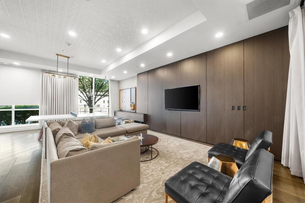 325 East Paces Ferry Road Northeast, Unit 504 Atlanta, GA 30305 - Photo 35 of 45 a living room with furniture and a flat screen tv