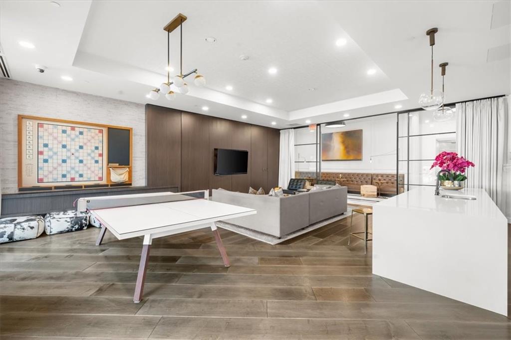 325 East Paces Ferry Road Northeast, Unit 504 Atlanta, GA 30305 - Photo 36 of 45 a living room with granite countertop furniture and a flat screen tv