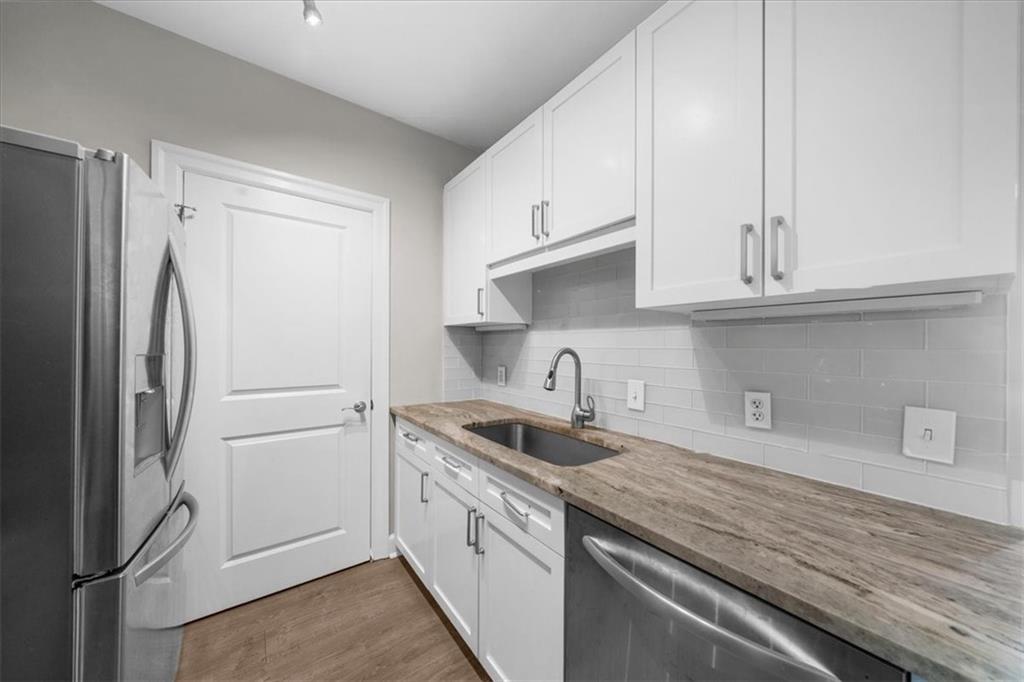 325 East Paces Ferry Road Northeast, Unit 504 Atlanta, GA 30305 - Photo 5 of 45 a kitchen with stainless steel appliances granite countertop a refrigerator sink and cabinets