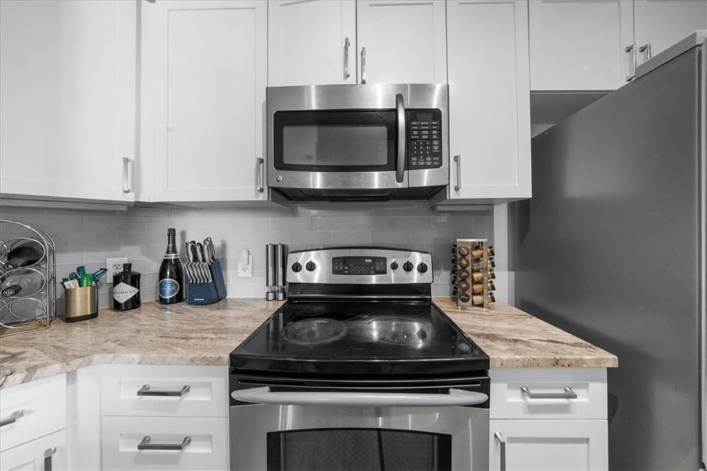 325 East Paces Ferry Road Northeast, Unit 504 Atlanta, GA 30305 - Photo 7 of 45 a stove top oven sitting inside of a kitchen
