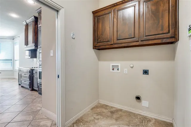 a bathroom with a granite countertop sink and washing machine