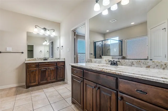a spacious bathroom with a granite countertop sink a mirror and a