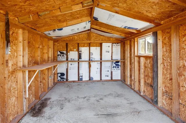 a view of an empty room with windows
