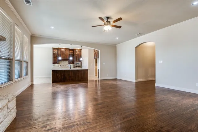 a view of a livingroom with a ceiling fan and hardwood floor