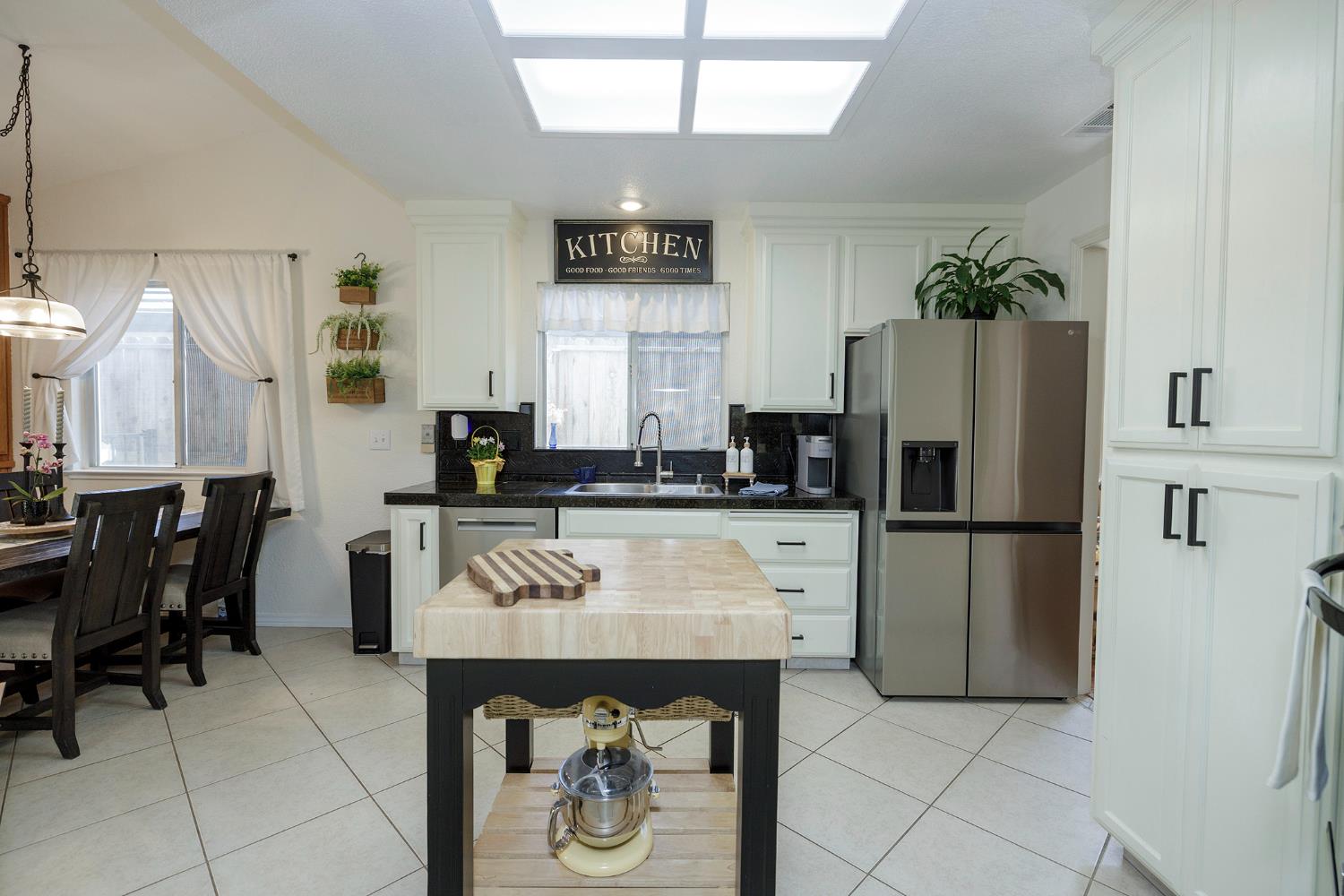 230 Meyenberg Avenue Ripon, CA 95366 - Photo 26 of 52 a kitchen with a refrigerator and a stove top oven