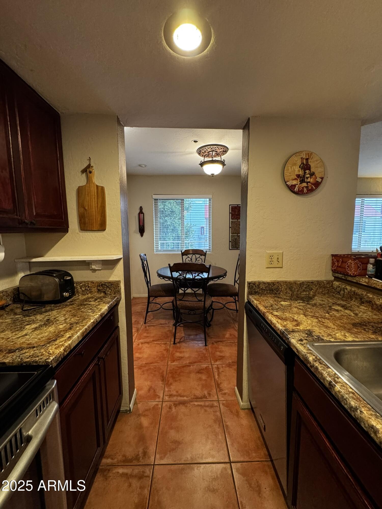 12123 West Bell Road, Unit 337 Surprise, AZ 85378 - Photo 11 of 50 a kitchen with a stove and a sink