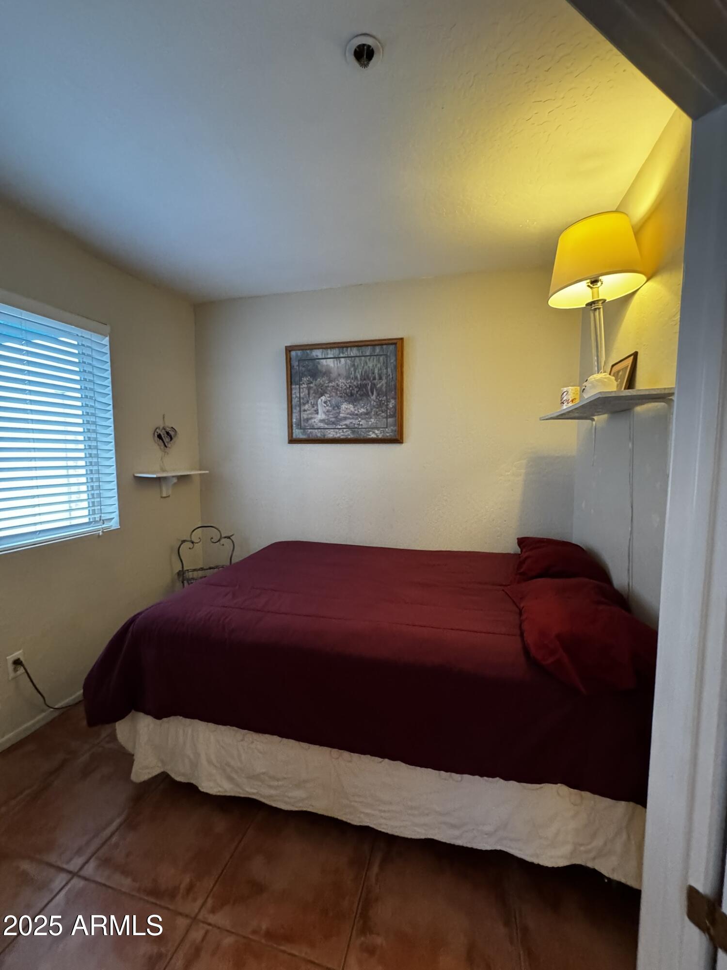 12123 West Bell Road, Unit 337 Surprise, AZ 85378 - Photo 20 of 50 a bedroom with a bed and a window