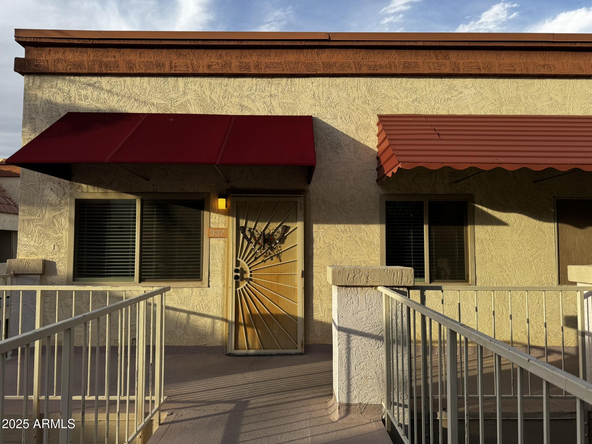 12123 West Bell Road, Unit 337 Surprise, AZ 85378 - Photo 2 of 50 a view of house with wooden deck and furniture