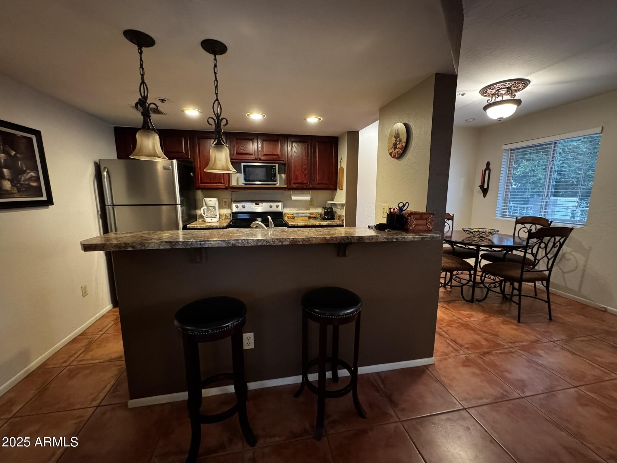 12123 West Bell Road, Unit 337 Surprise, AZ 85378 - Photo 22 of 50 a dining table with chairs and a wooden floors