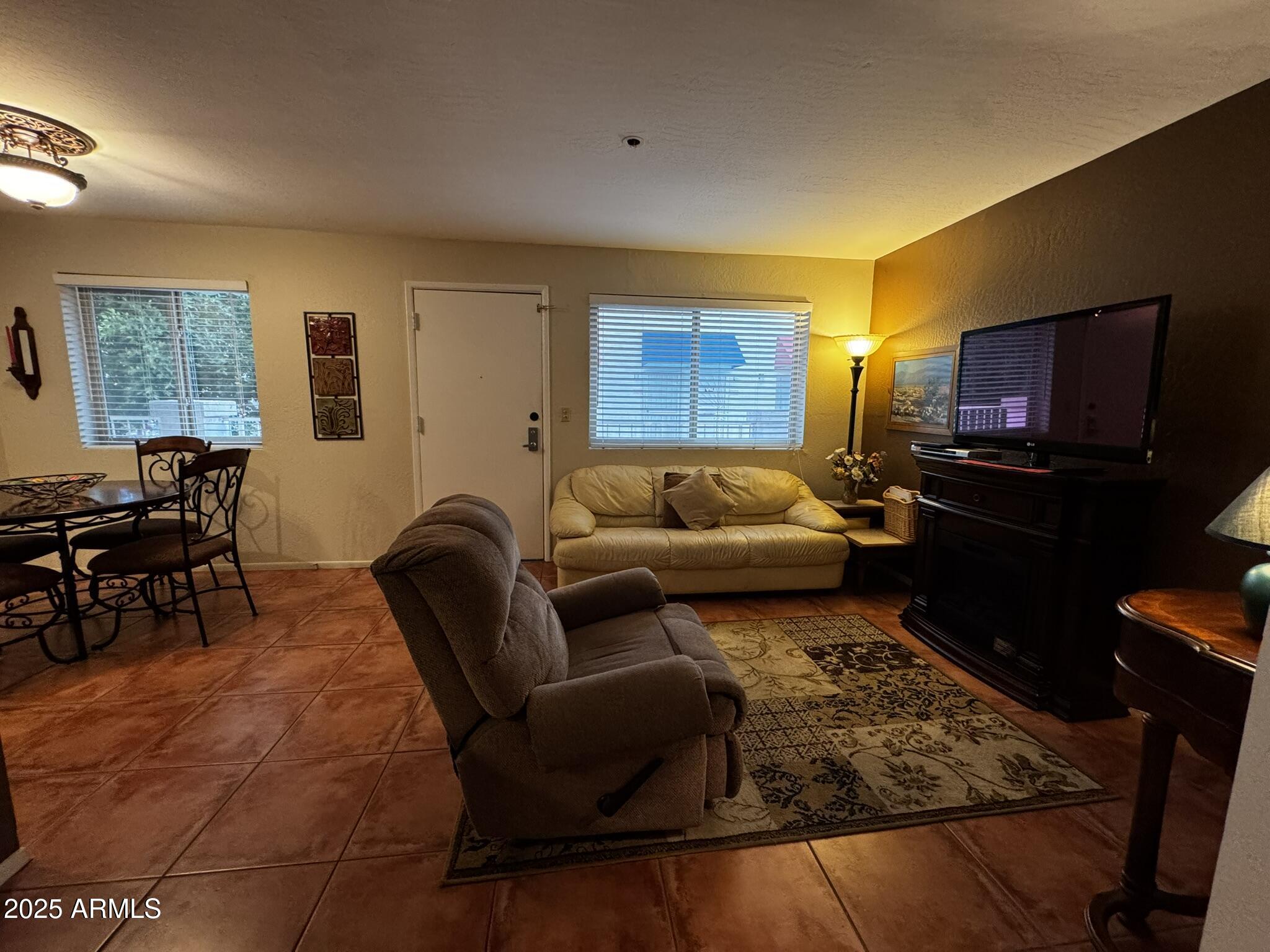 12123 West Bell Road, Unit 337 Surprise, AZ 85378 - Photo 23 of 50 a living room with furniture and a flat screen tv