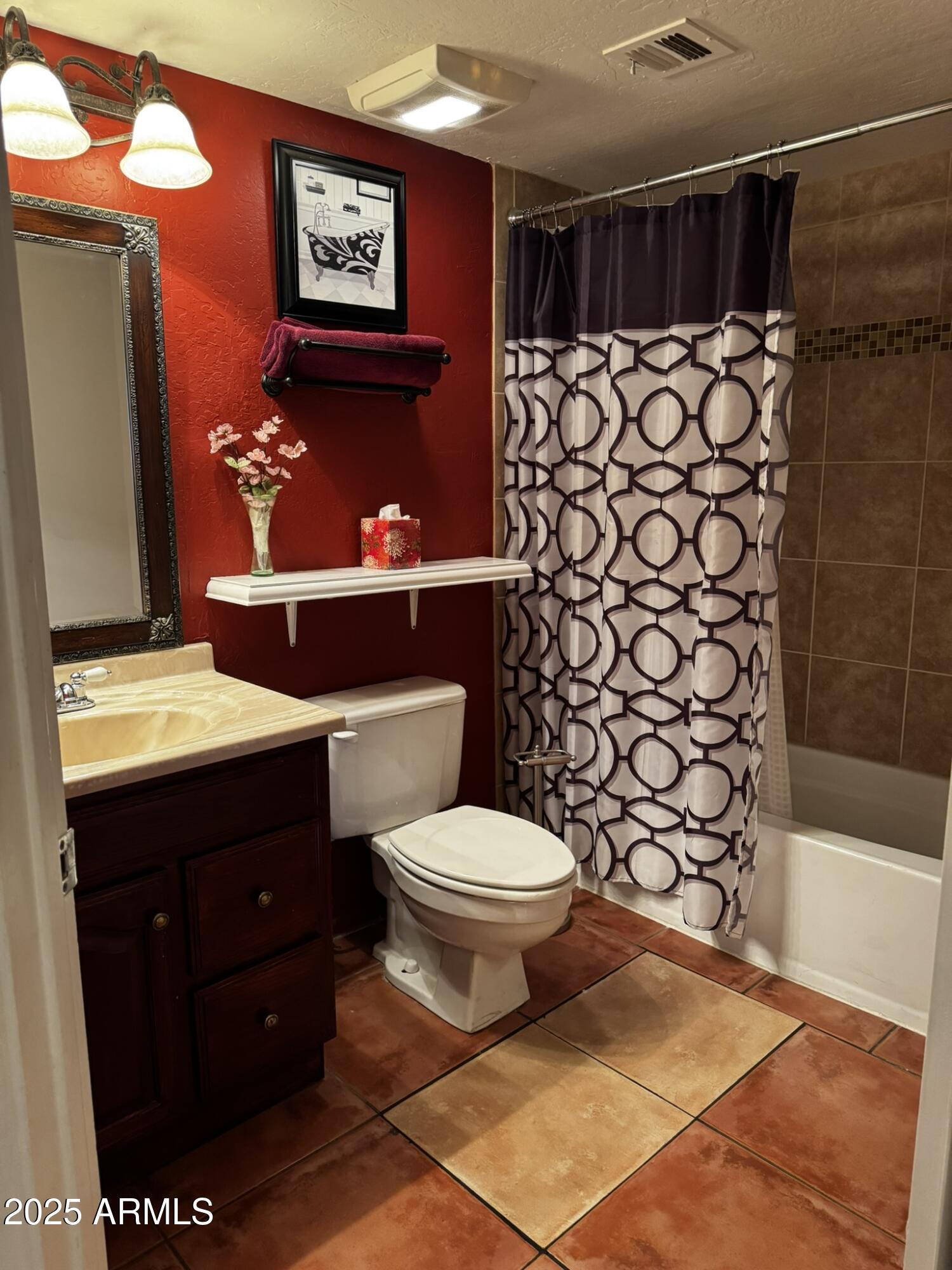 12123 West Bell Road, Unit 337 Surprise, AZ 85378 - Photo 27 of 50 a bathroom with a toilet and a shower curtain