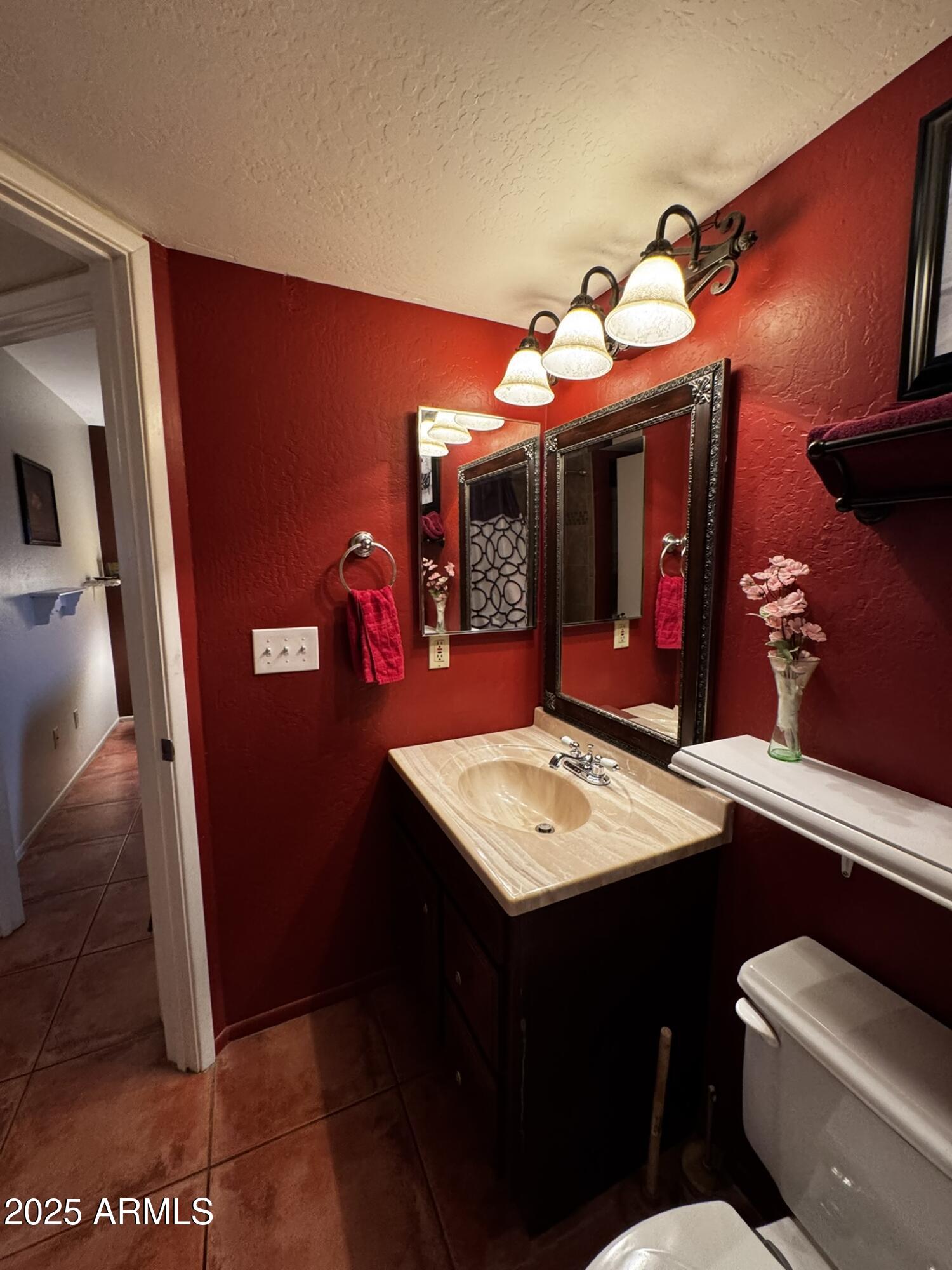 12123 West Bell Road, Unit 337 Surprise, AZ 85378 - Photo 29 of 50 a bathroom with a sink mirror and vanity
