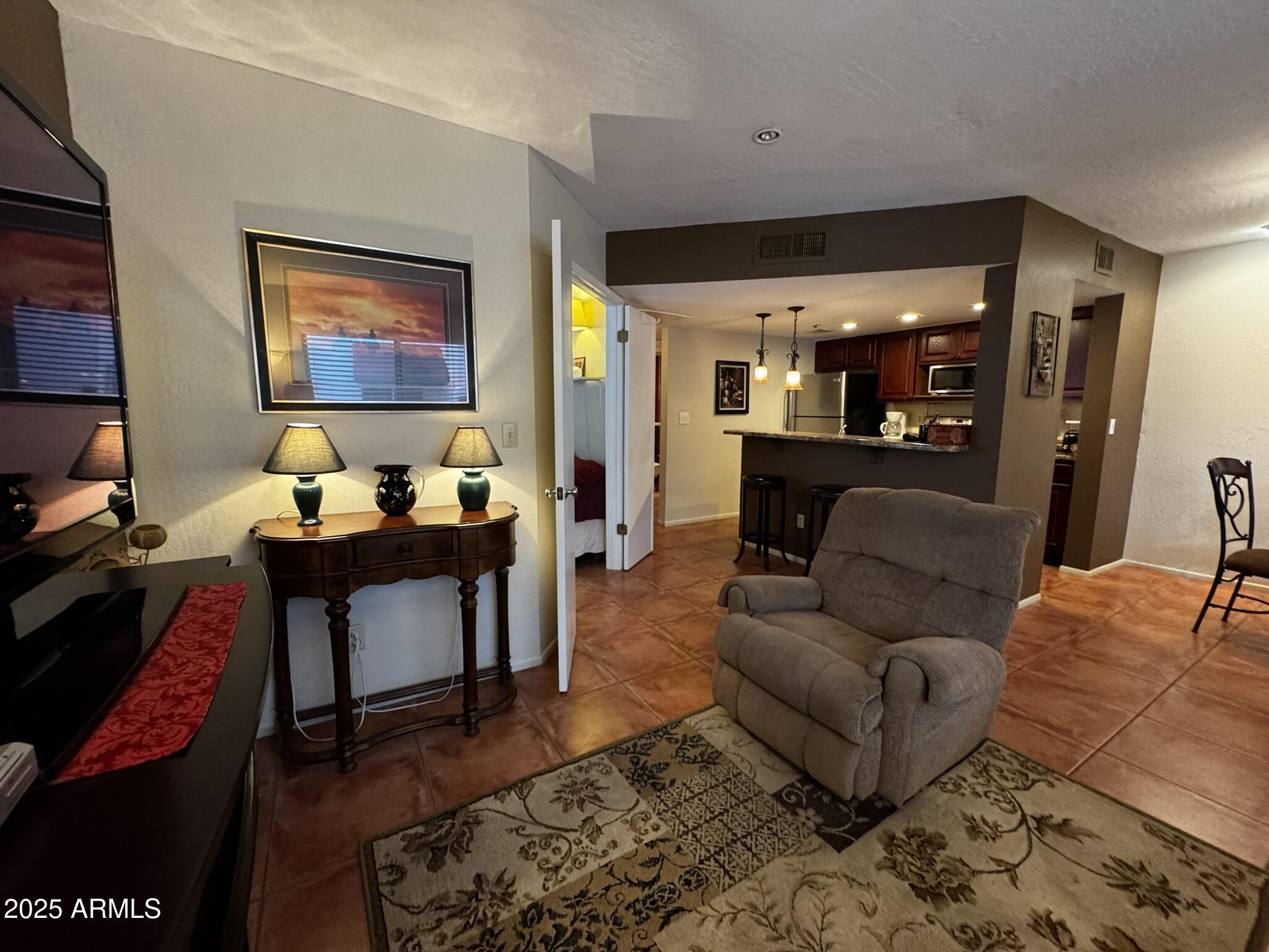 12123 West Bell Road, Unit 337 Surprise, AZ 85378 - Photo 3 of 50 a living room with furniture and wooden floor