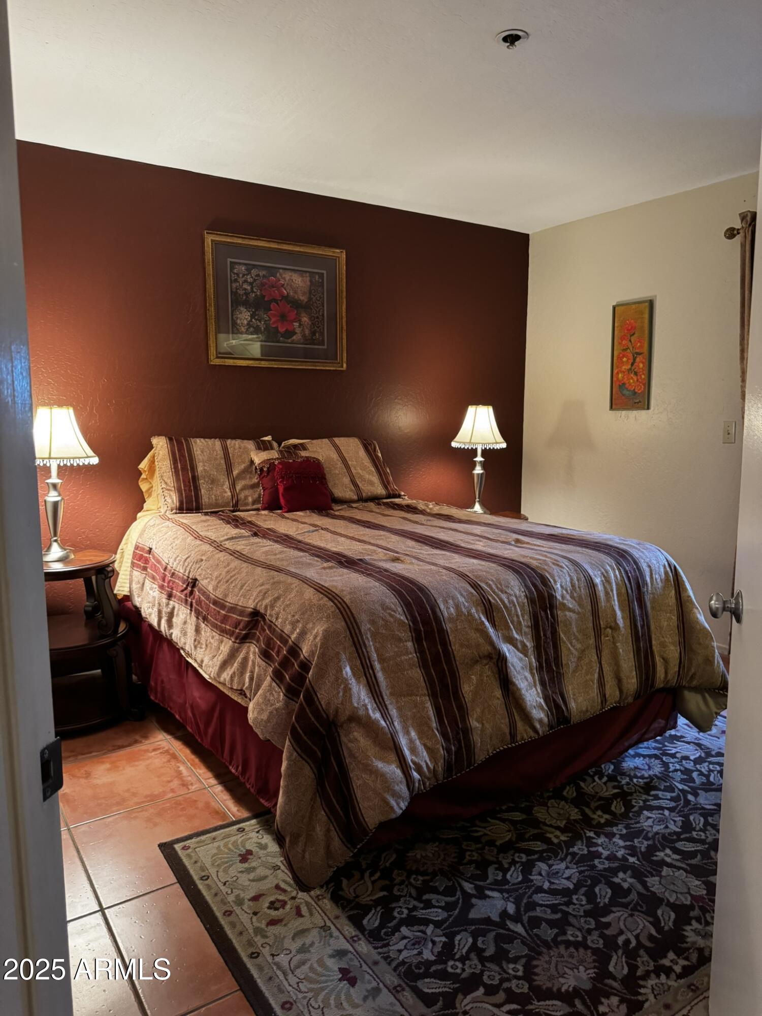 12123 West Bell Road, Unit 337 Surprise, AZ 85378 - Photo 31 of 50 a bedroom with a bed lamp and a dresser