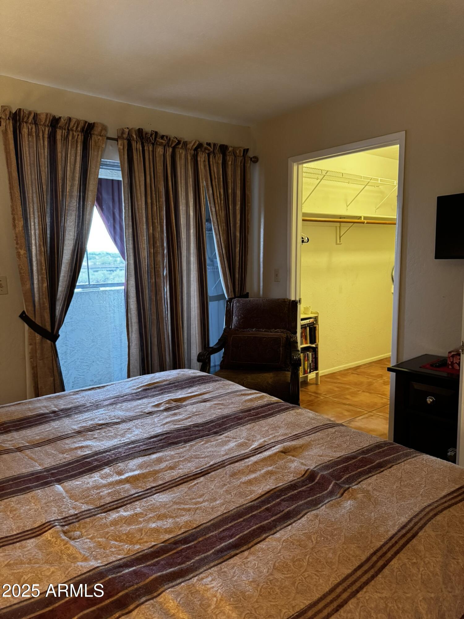 12123 West Bell Road, Unit 337 Surprise, AZ 85378 - Photo 32 of 50 a bedroom with a bed and a television