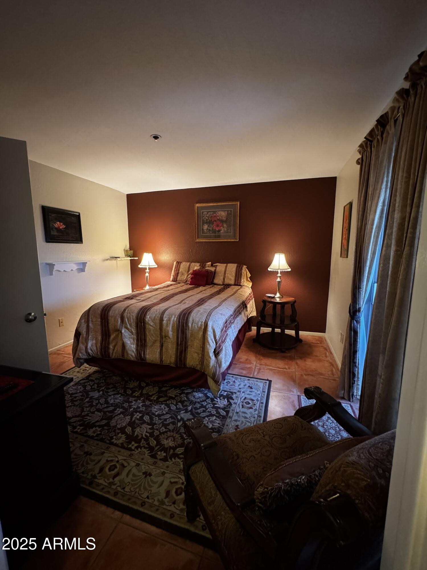 12123 West Bell Road, Unit 337 Surprise, AZ 85378 - Photo 34 of 50 a bedroom with double bed and a lamp