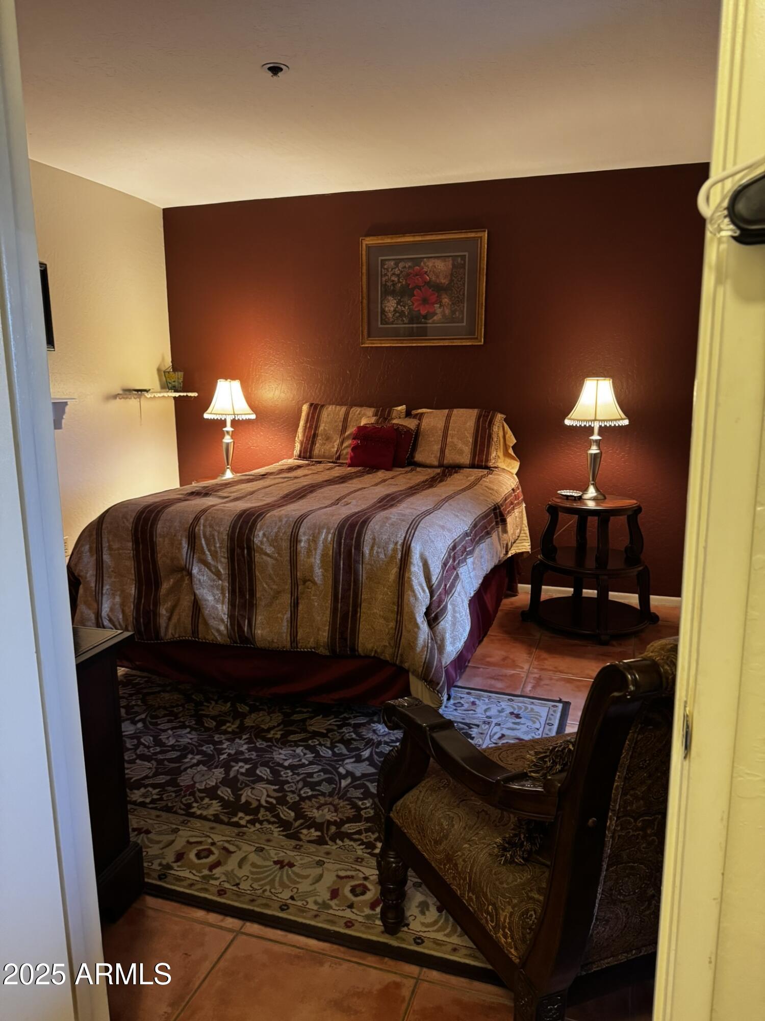 12123 West Bell Road, Unit 337 Surprise, AZ 85378 - Photo 35 of 50 a bed sitting in a bedroom next to a lamp