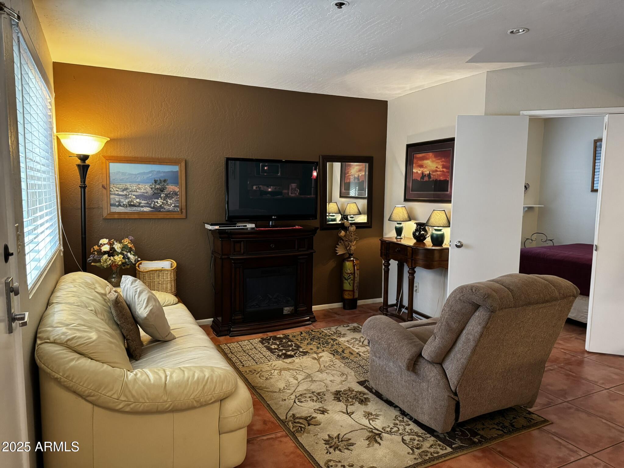 12123 West Bell Road, Unit 337 Surprise, AZ 85378 - Photo 6 of 50 a living room with furniture and a flat screen tv