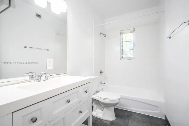 a bathroom with a sink a toilet and a tub