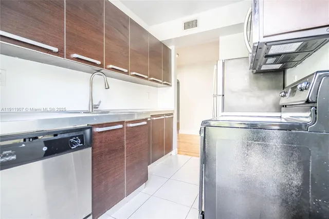 a kitchen with stainless steel appliances granite countertop a sink and a stove