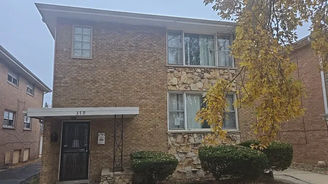 a front view of a house with brick walls