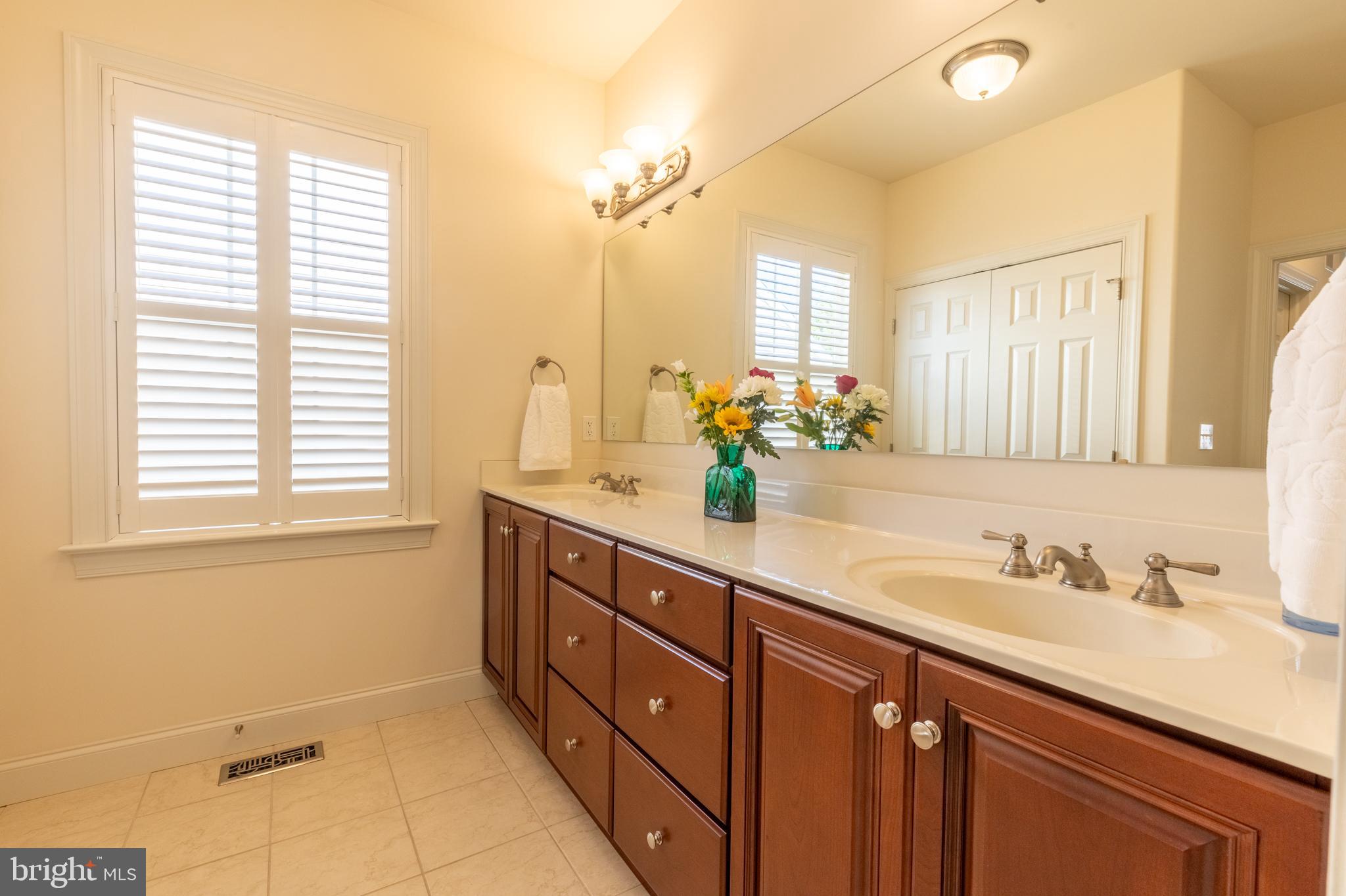 101 Cornwall Road, Unit 116 Landenberg, PA 19350 - Photo 21 of 30 a bathroom with a double vanity sink and a mirror