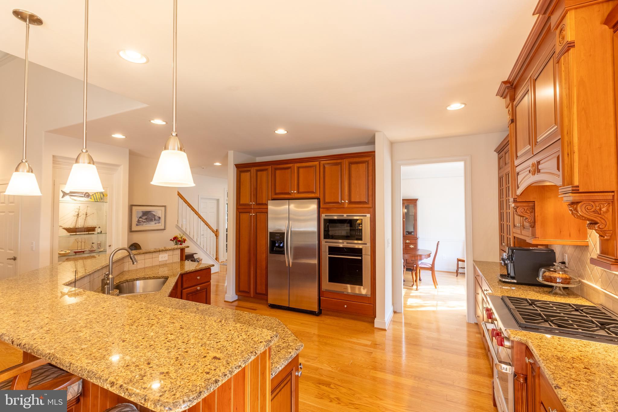 101 Cornwall Road, Unit 116 Landenberg, PA 19350 - Photo 7 of 30 a view of a kitchen with kitchen island granite countertop a refrigerator and a sink
