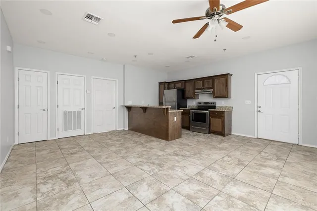 a view of kitchen with microwave and cabinets